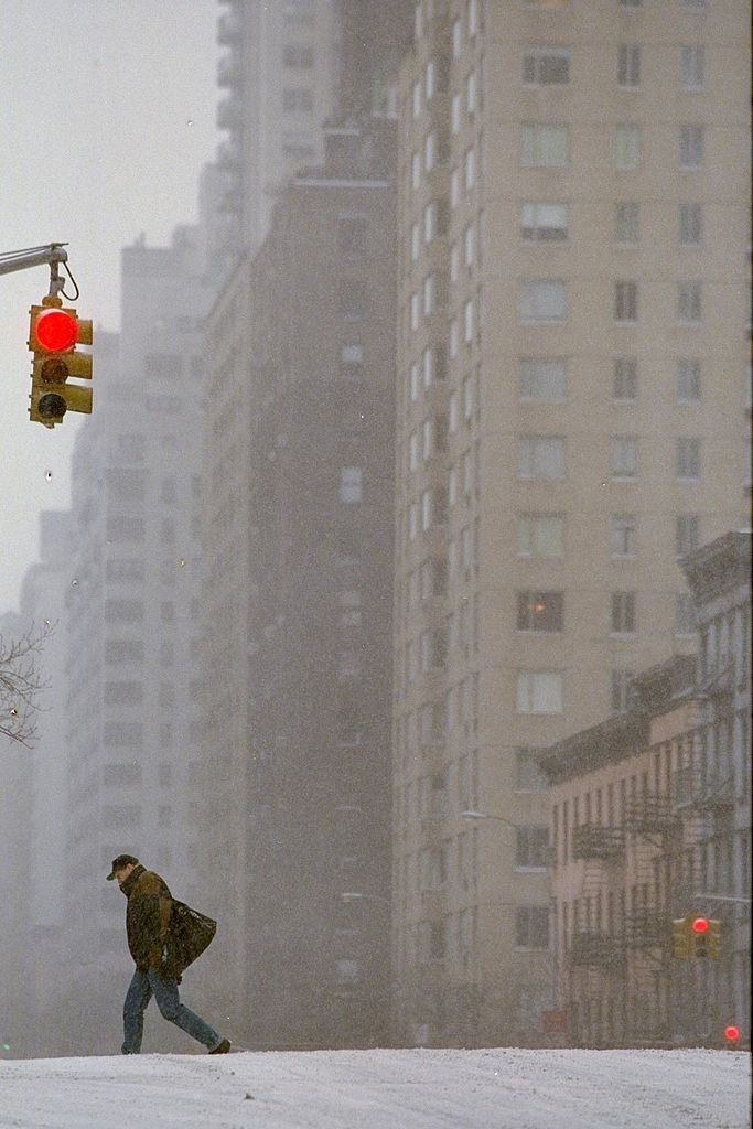 #48 Pedestrian walks along a desolate First Ave. during a blizza