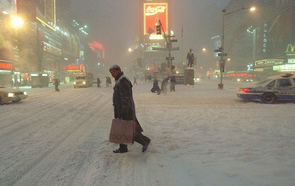 #50 Pedestrian carefully crosses the street in Times Square during the blizzard, New York City, 1996