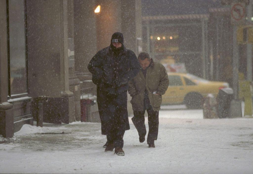 #53 Pedestrians slowly make their way up 57th St. during a blizzard, New York City, 1996