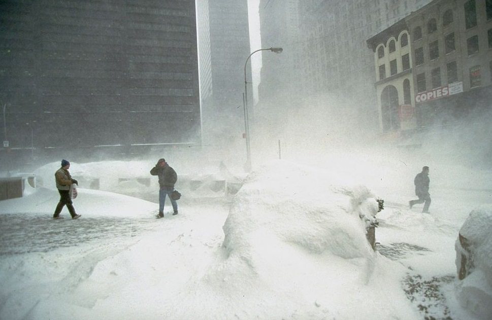 #55 Several hardy souls crossing windy, snowswept plaza during Blizzard of 1996, in financial district.