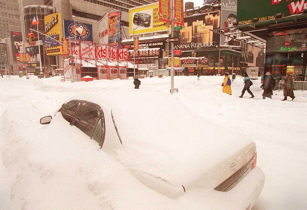 #14 Pedestrians make their way past a buried car in New York’s Times Square 08