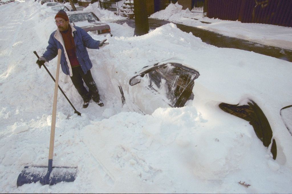 #79 Earl Lessey starts digging one of his two cars out of the snow in Carroll Gardens after a blizzard left them buried.