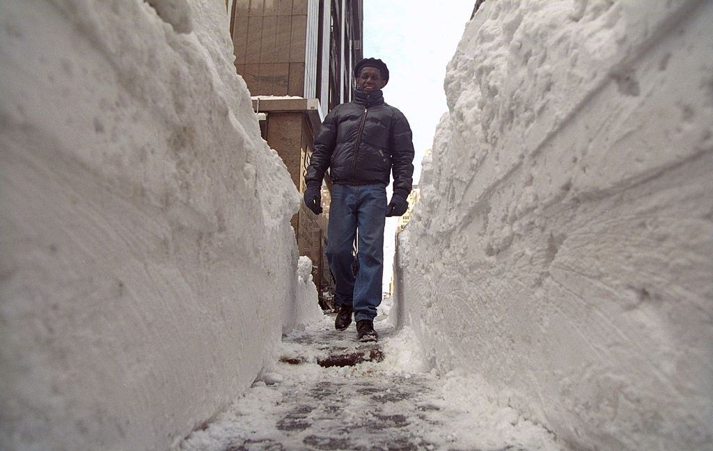 #81 Huge tunnels dug out of the snow allow New Yorkers to get onto sidewalks as they head back to work after a blizzard.