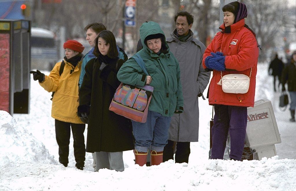 #87 Pedestrians look at snow filled intersections on Ninth Ave. as they try to map out a way to get across the street after a blizzard.