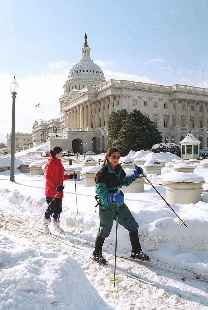 #89 Jennifer Pitt (right) and Ann Crystal make their way past the U.S. Capitol on skis, since a large amount of snow remains on the ground as a result of a blizzard.