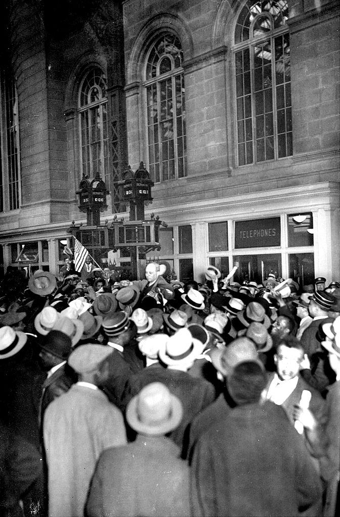 #58 A cheering, milling crowd carries Samuel, 1933