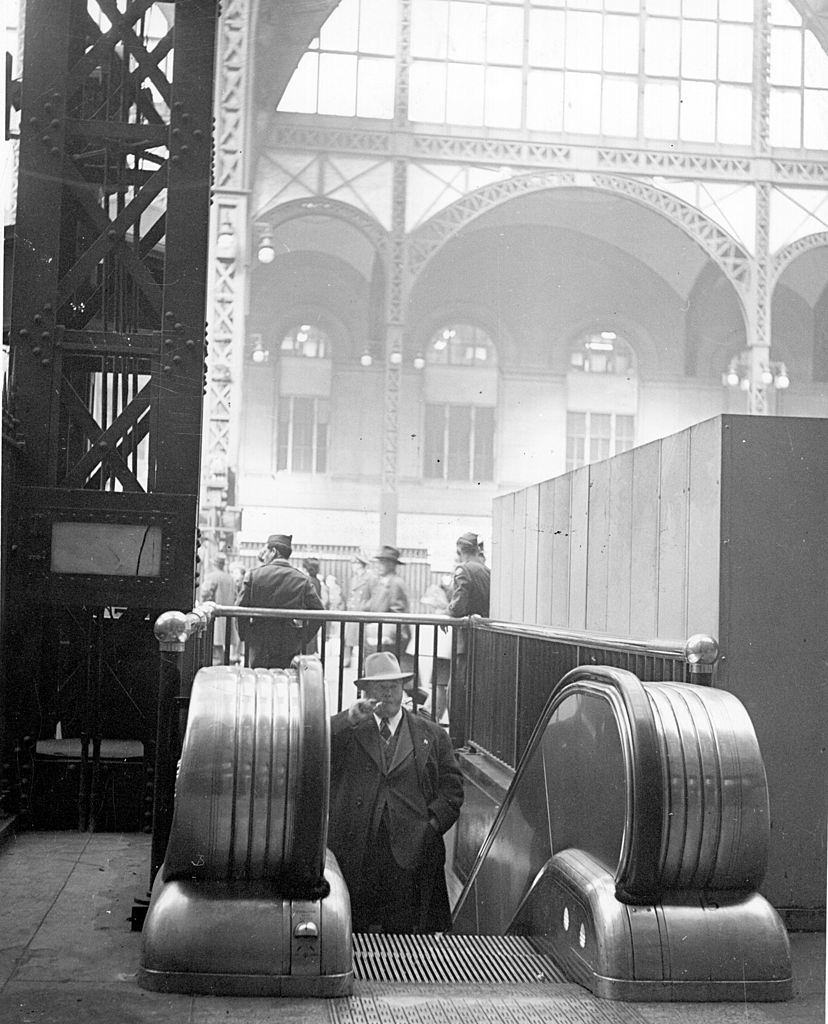 #62 A man approaches the top of an escalator at Pennsylvania Railroad Station, New York, 1940