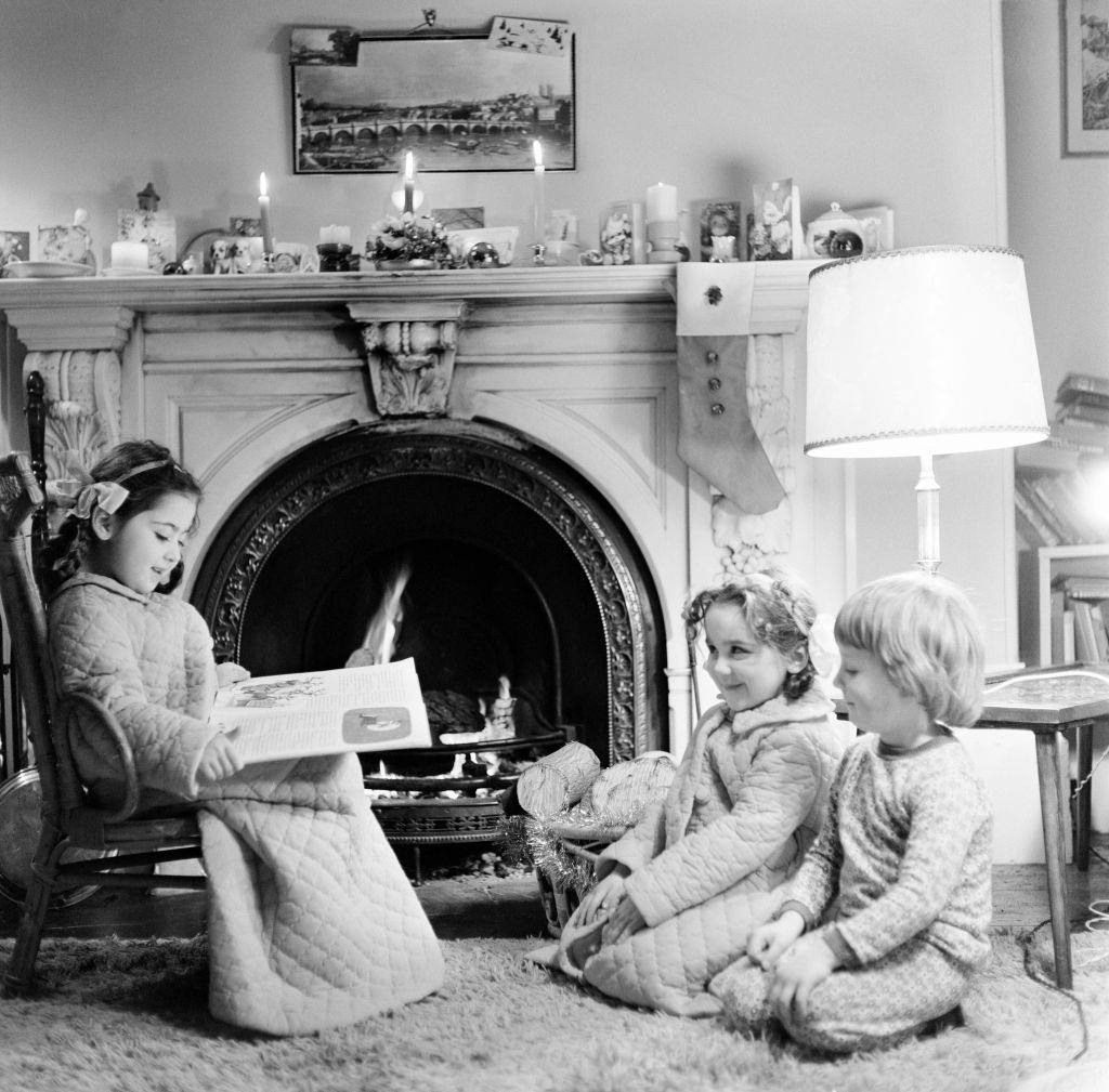 #108 Christmas Eve, Children reading bedtime stories as they wait for Santa, Newcastle, Tyne and Wear. Posed picture taken 18th December 1974.