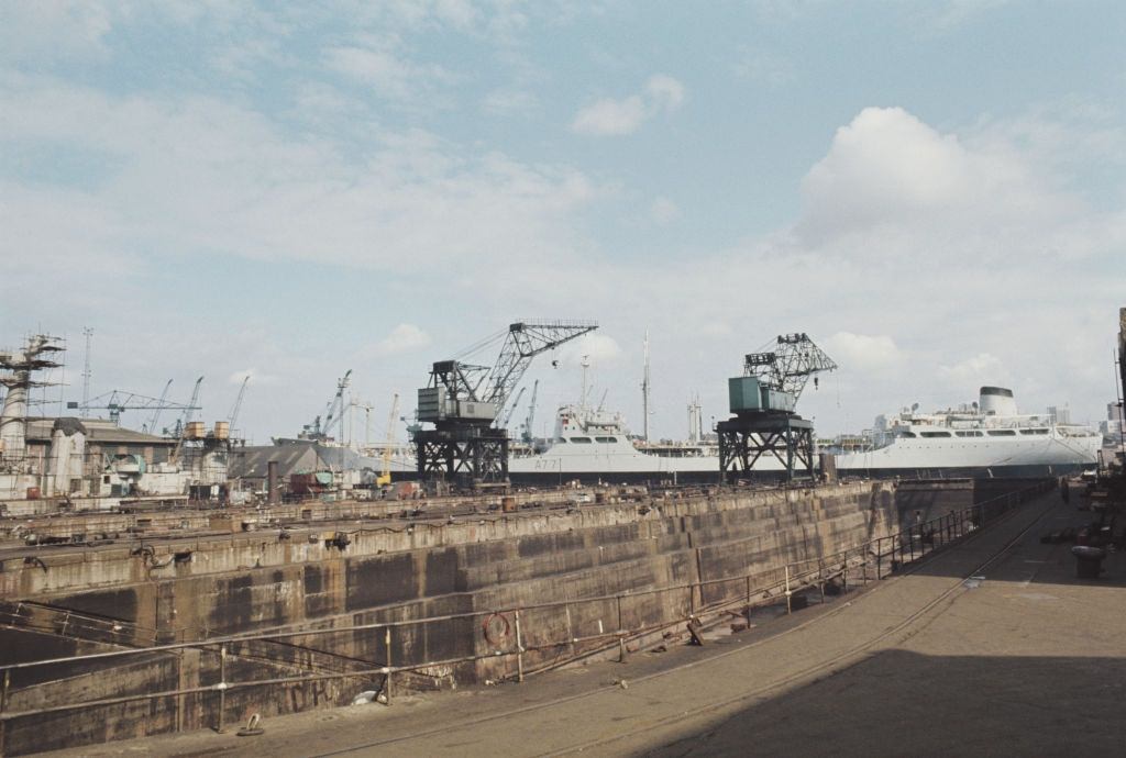 #67 Cranes standing idle next to an empty dry dock at the Swan Hunter shipbuilding complex located on the River Tyne at Wallsend near Newcastle upon Tyne, 1972.