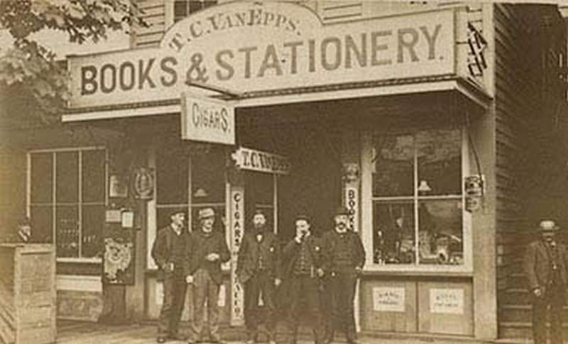 #34 A one-story wooden building identified as the T.C. Van Epps Books and Stationery Store, Olympia, 1876.