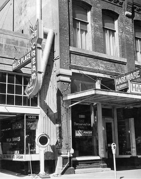 #22 Bill’s Place ice cream and hardware shop fronts showing earthquake damage, Olympia, April 1949