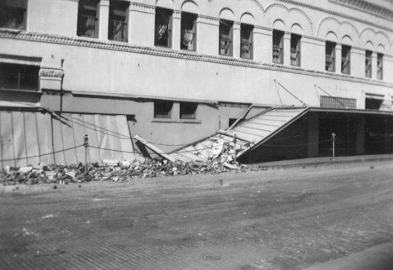 #25 Damaged building canopy in downtown Olympia after an earthquake, April 1949