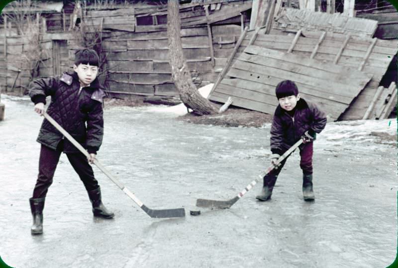 #112 Two boys playing ice hockey