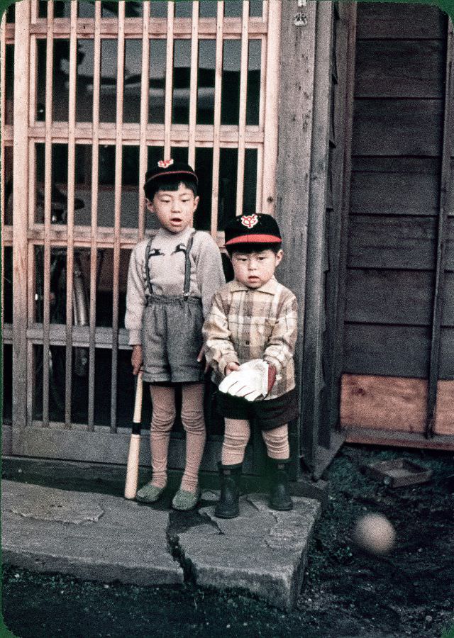 #115 Two Japanese kids (one with a baseball glove, one with a bat) wearing Yomiuri Giants caps