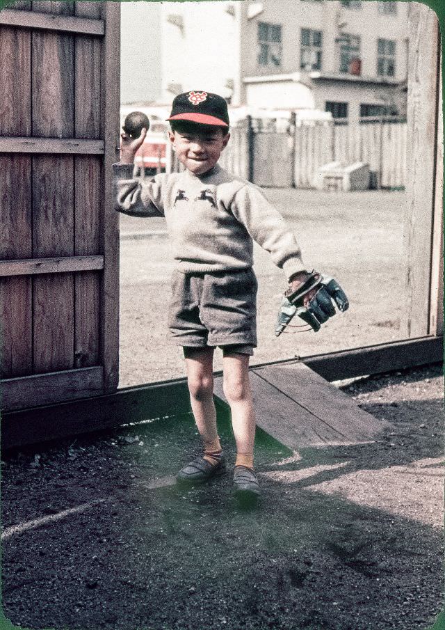 #128 Boy with a baseball glove, baseball bat, and Yomiuri Giants cap