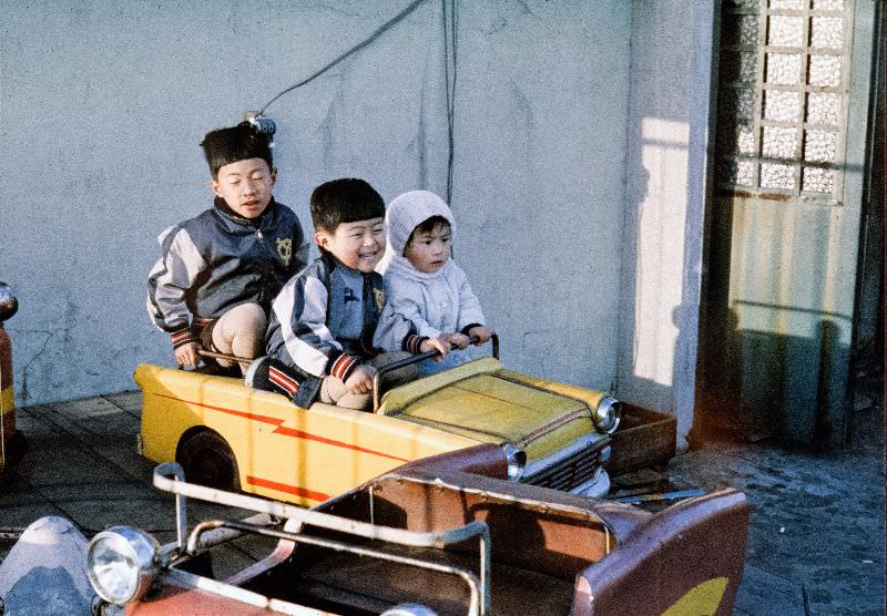 #135 Kids driving a toy metal car and wearing Yomiuri Giants jackets