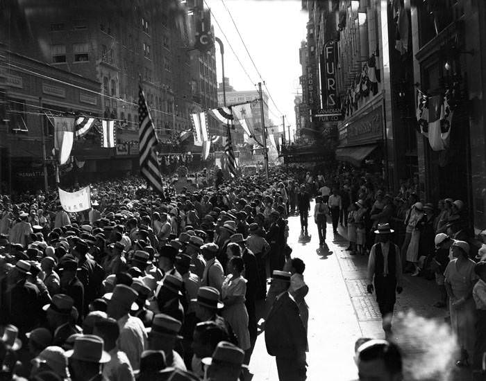 #164 Crowd watching Battle of Flowers Parade in 200 block of E. Houston Street, San Antonio,. 1936