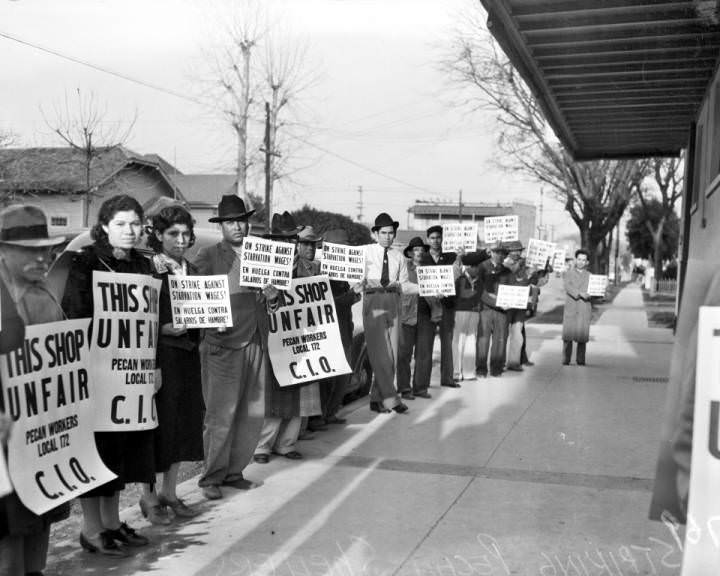 #236 Striking pecan shellers picketing on the sidewalk in front of the Southern Pecan Shelling Company at 135 East Cevallos Street, 1938