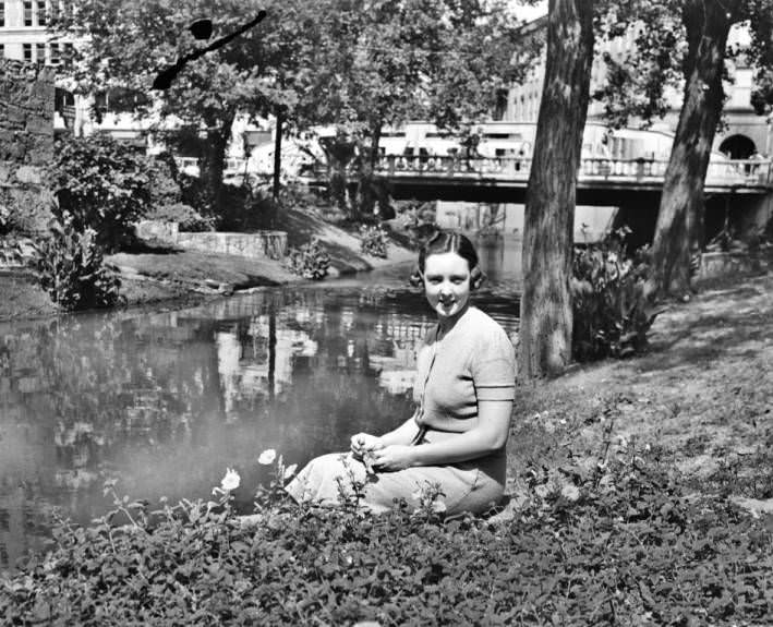 #238 Mrs. Donelson Gillis seated on the banks of the San Antonio River, along the side of Crockett, 1938