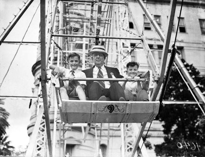 #42 John Williams and children on ferris wheel at 1938 Fiesta Carnival, 1938