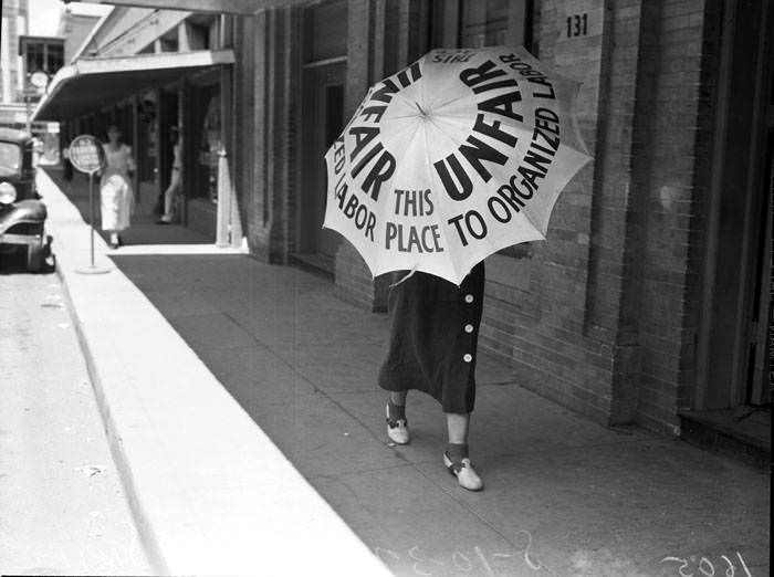 #63 San Antonio Laundry strike – View of women pickets carrying umbrellas, 1937