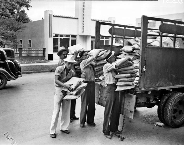 #67 Street vendors unloading cushions for the 1937 Battle of Flowers Parade, 1937