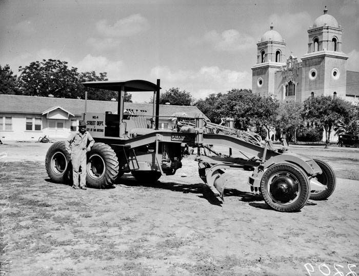 #77 W.W. Lorrilard standing beside new road grader, 1939