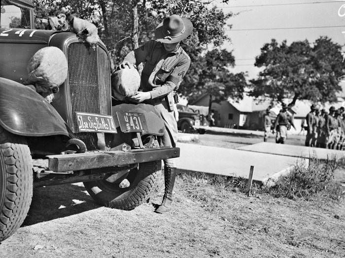 #91 Pvt. E.G. Clohecy placing covers on headlights, 1937