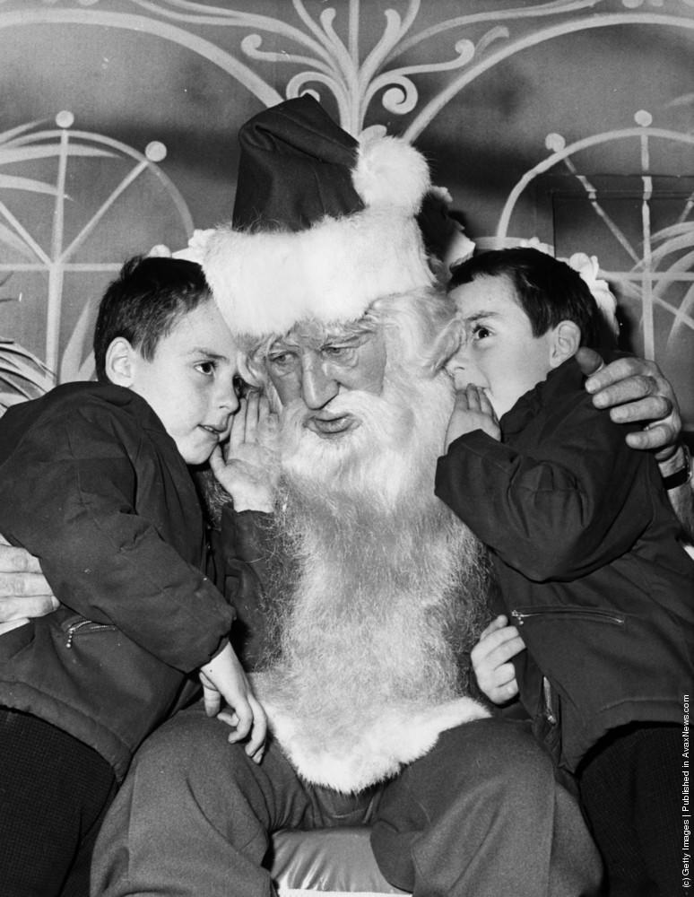 #28 A pair of five year old twins tell Father Christmas what they want for their presents at Selfidges in Oxford Street, 10th December 1970