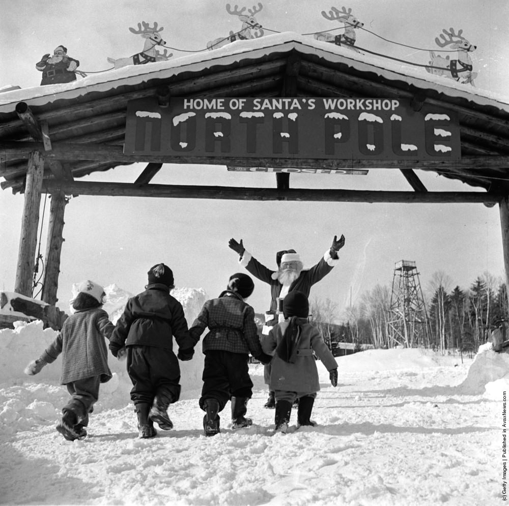 #29 Santa Claus welcomes young visitors to his North Pole Workshop in the Adirondack Mountains of New York State, 1955