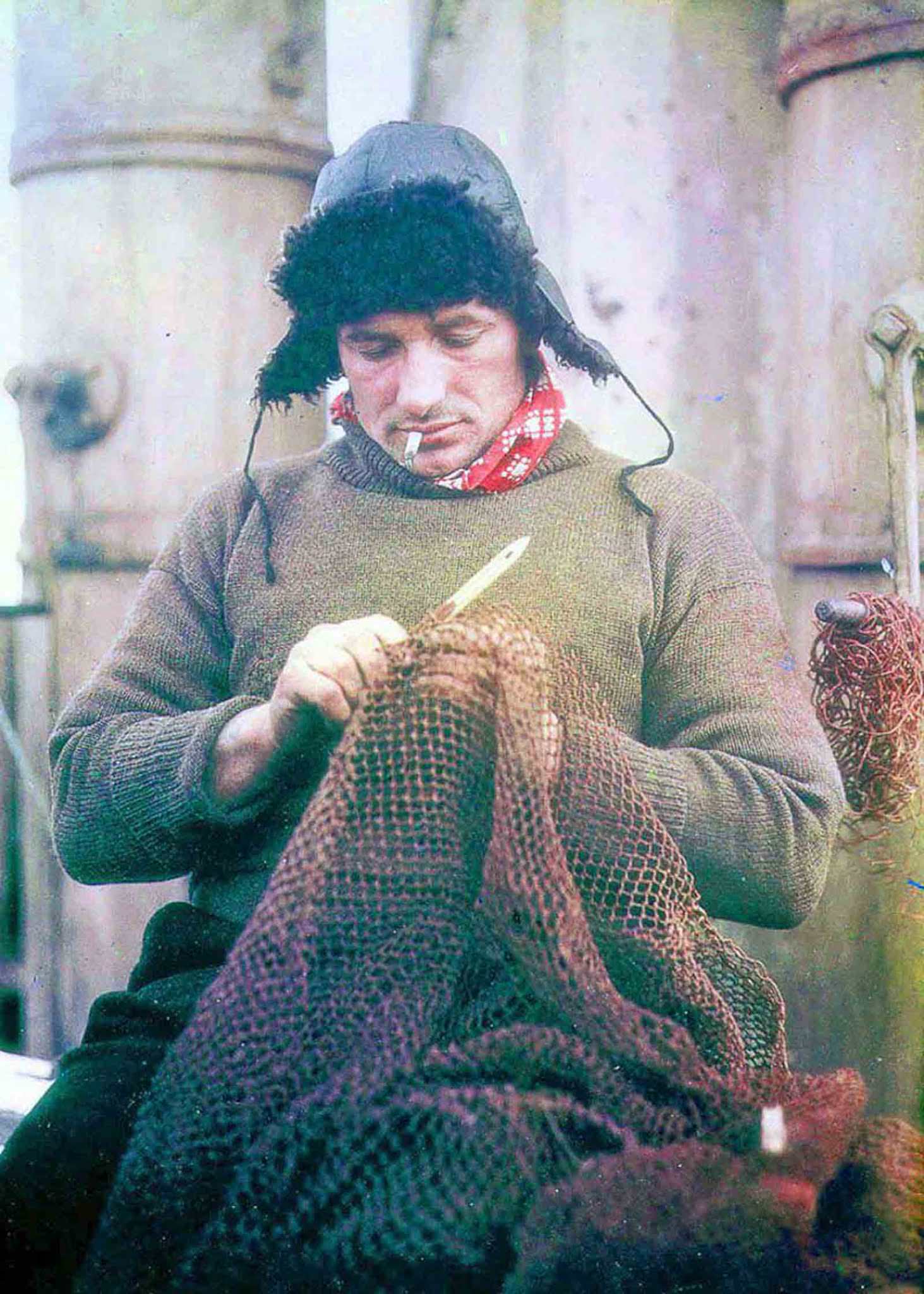#10 John Vincent, Boatswain, mends a net on the Endurance.