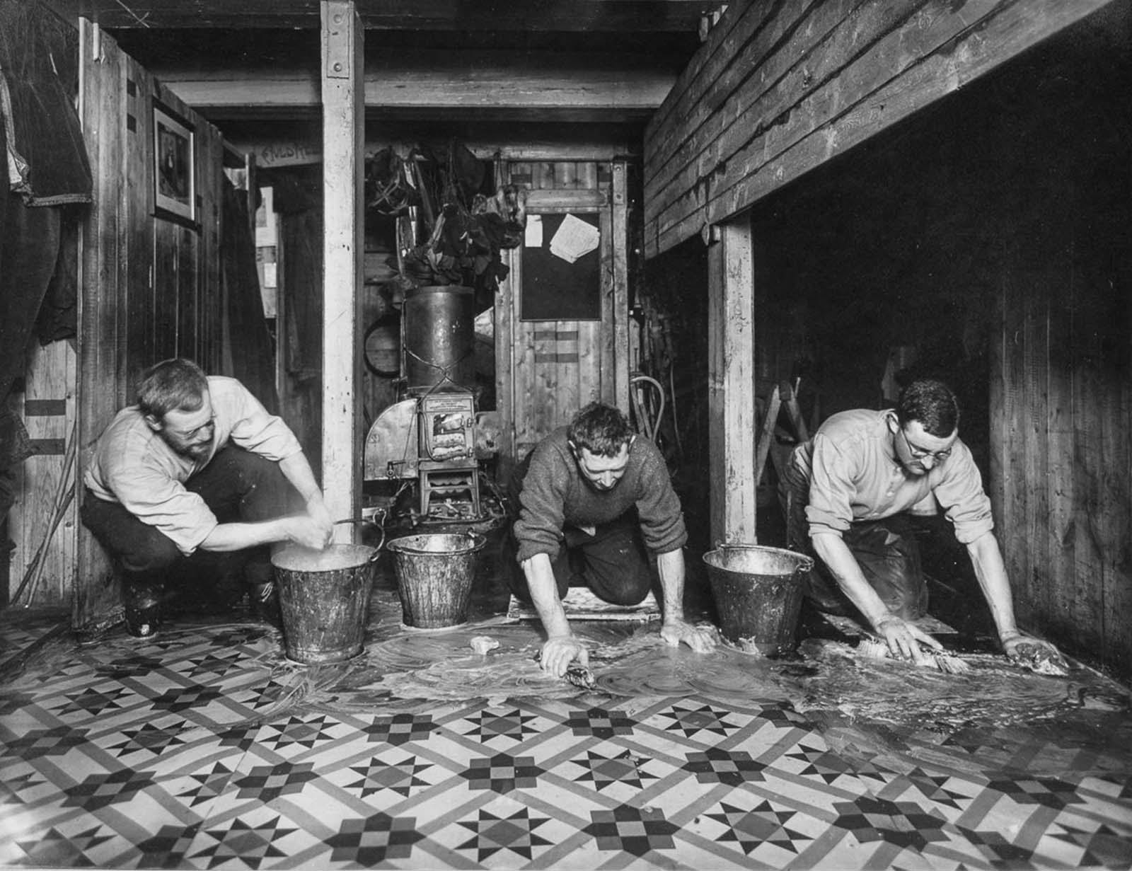 #39 James Wordie, Alfred Cheetham and Alexander Macklin scrub the floors of the “The Ritz” aboard Endurance.