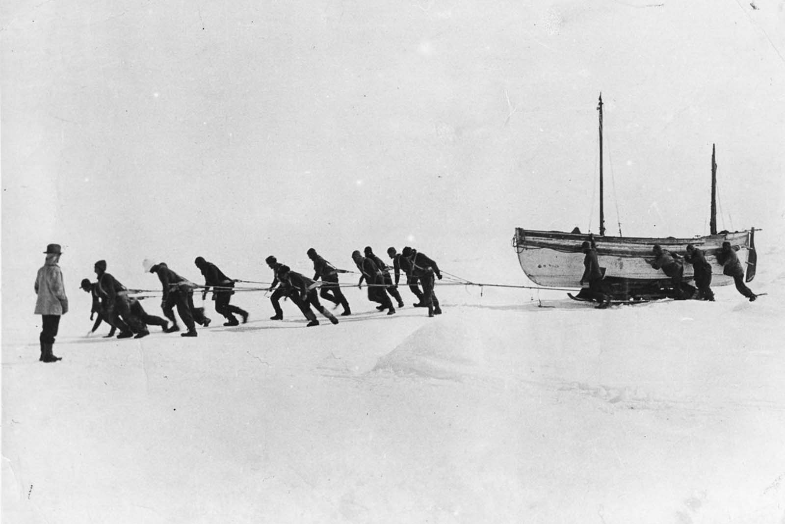 #47 Crew members haul one of the lifeboats across the ice after the loss of Endurance.