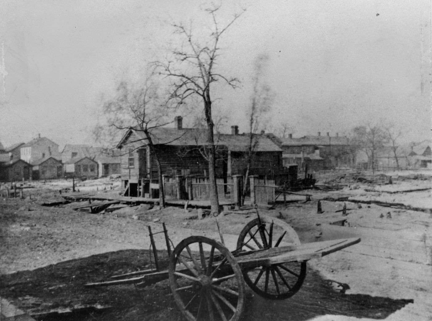 #33 In this photo taken shortly after the Great Chicago Fire of 1871, the O’Leary house, center, still stands, but only rubble is left of its barn, right.