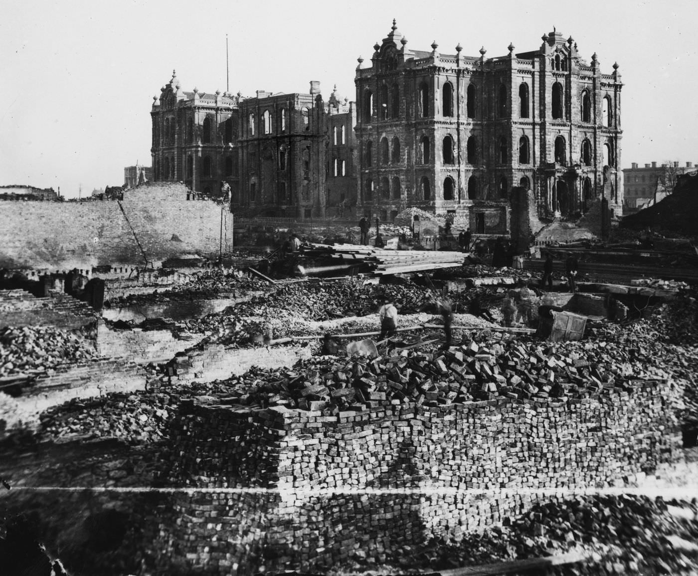 #47 Workers walk through the wreckage near the remains of the courthouse and City Hall, background, in the aftermath of the Great Chicago Fire.