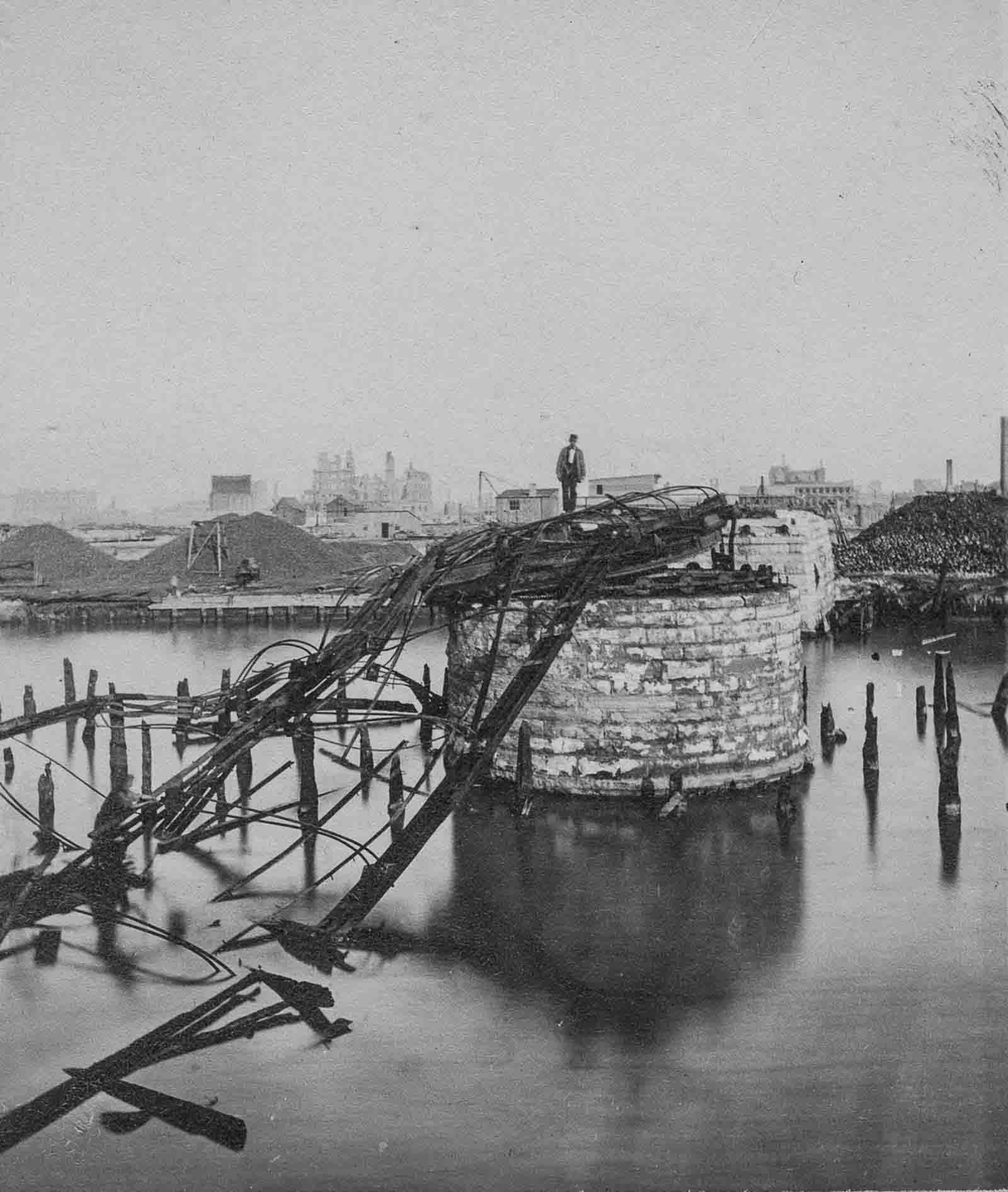 #8 A man stands on the remains of the Van Buren Street Bridge.