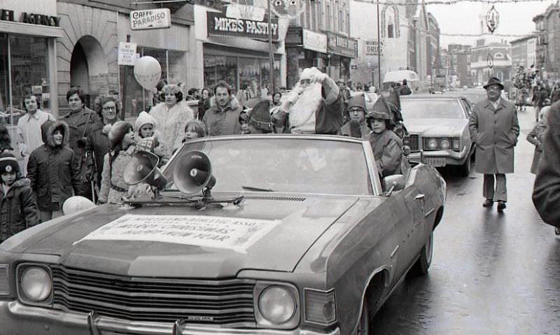 #19 Santa Claus in car with children dressed as elves in North End Christmas Parade on Hanover Street