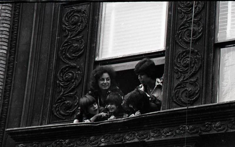 #31 Woman and children watch North End Christmas parade from window