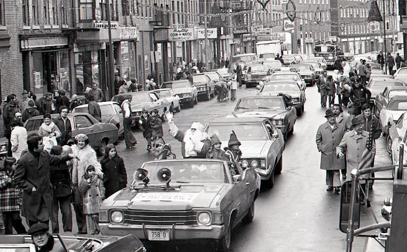 #35 Santa Claus in car with children dressed as elves in North End Christmas Parade on Hanover Street