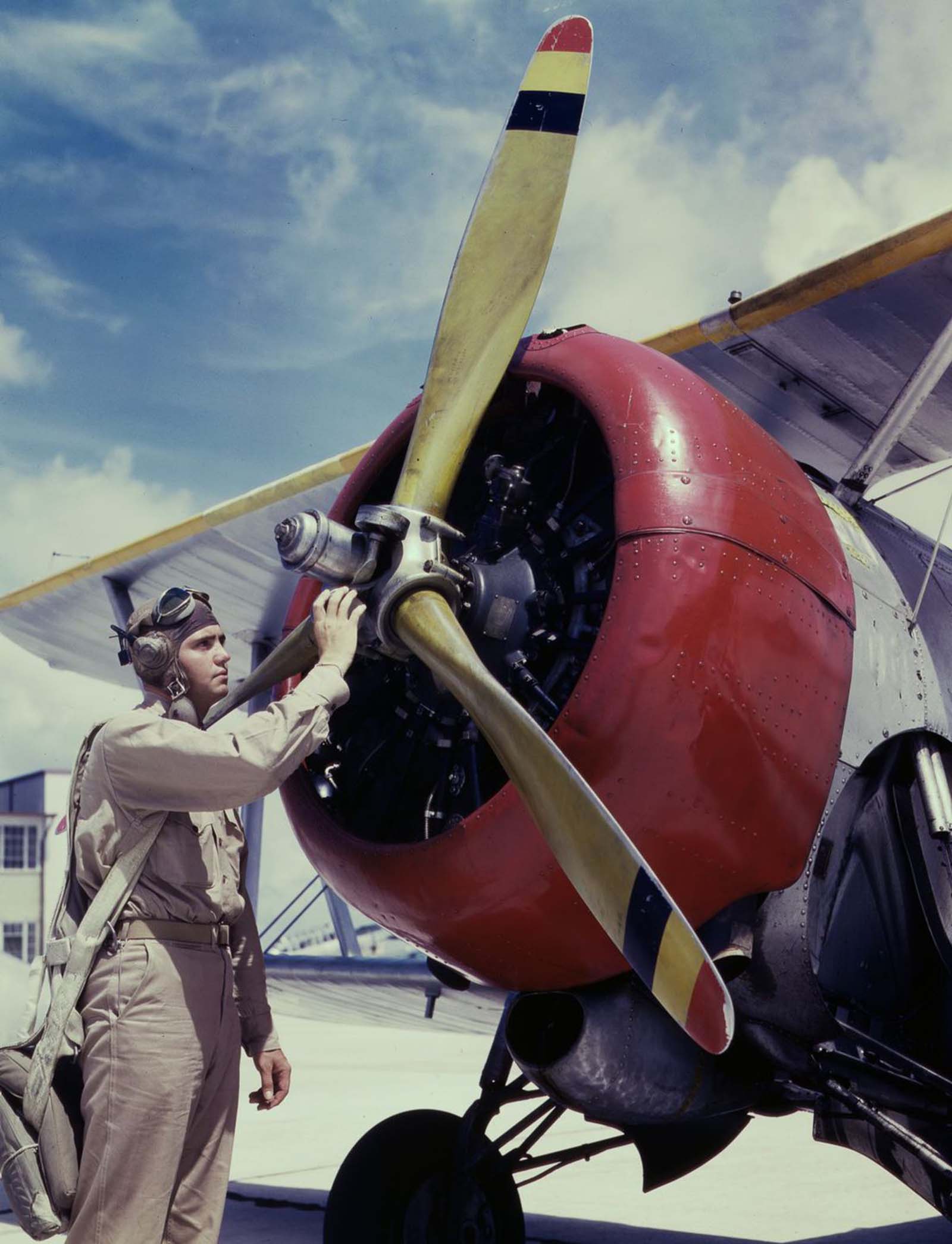 #1 Aviation Cadet Thanas inspects an airplane engine.