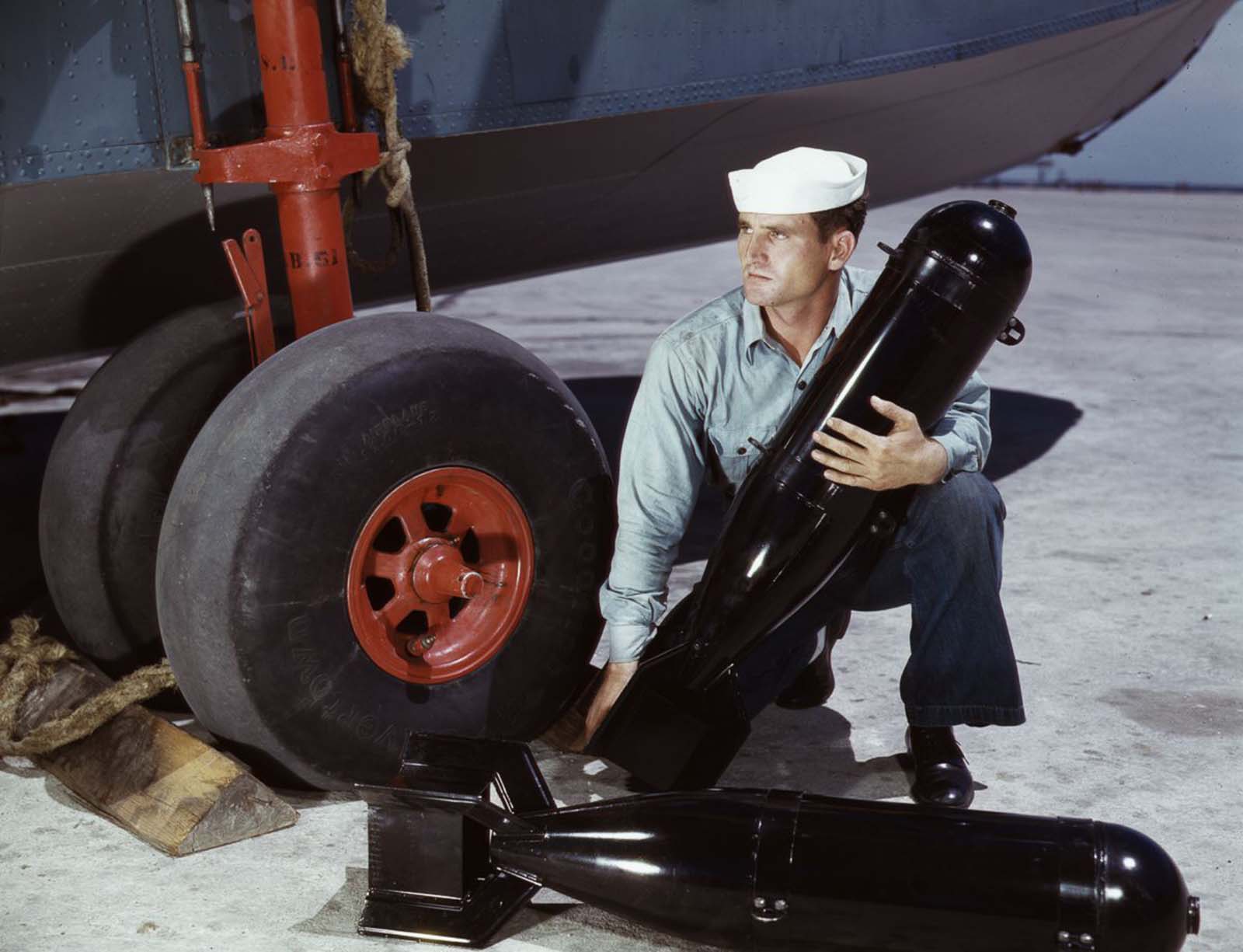 #16 J.D. Estes loads munitions into a plane.