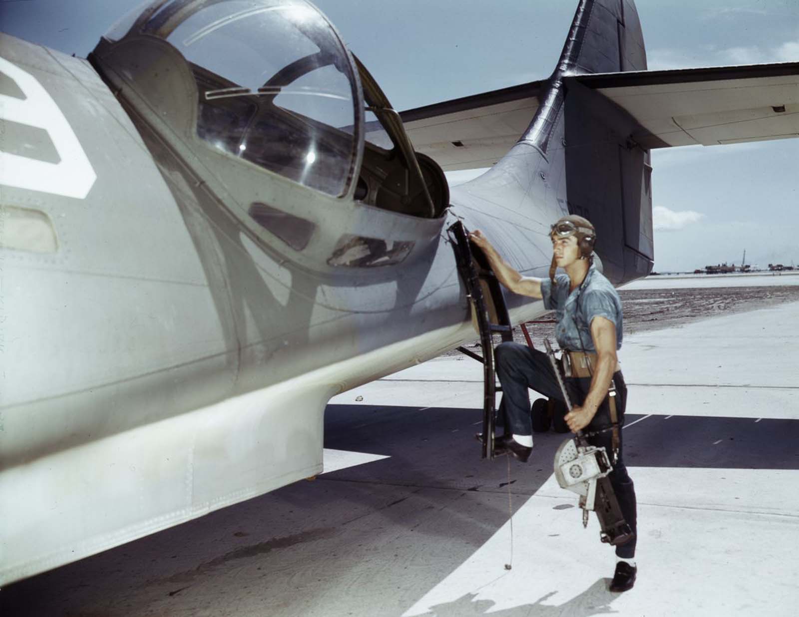 #17 Aviation Ordnance Mate Jesse Rhodes Waller prepares to install a .30-caliber machine gun in a Navy PBY plane.