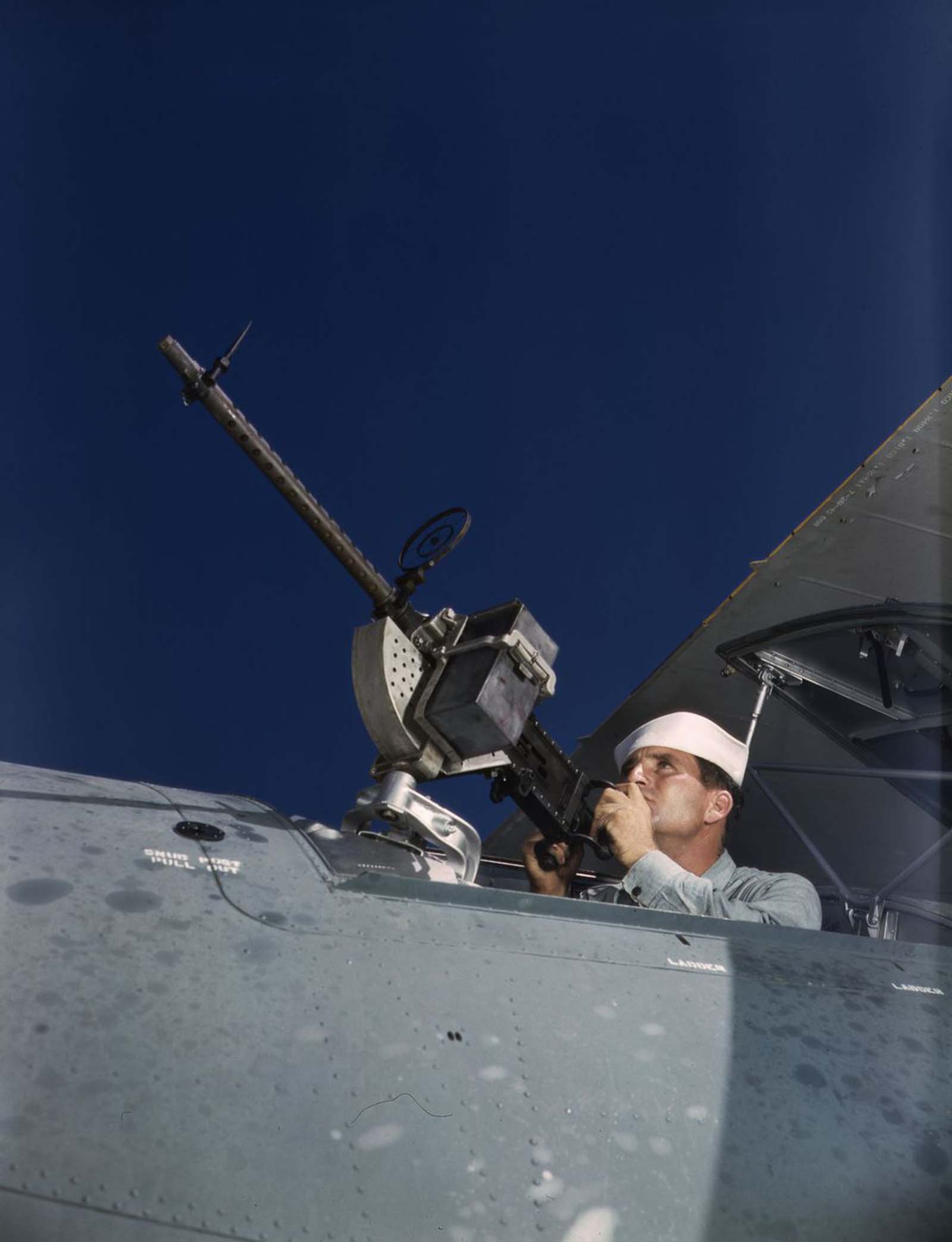 #19 J.D. Estes tests the sights on a newly installed machine gun.