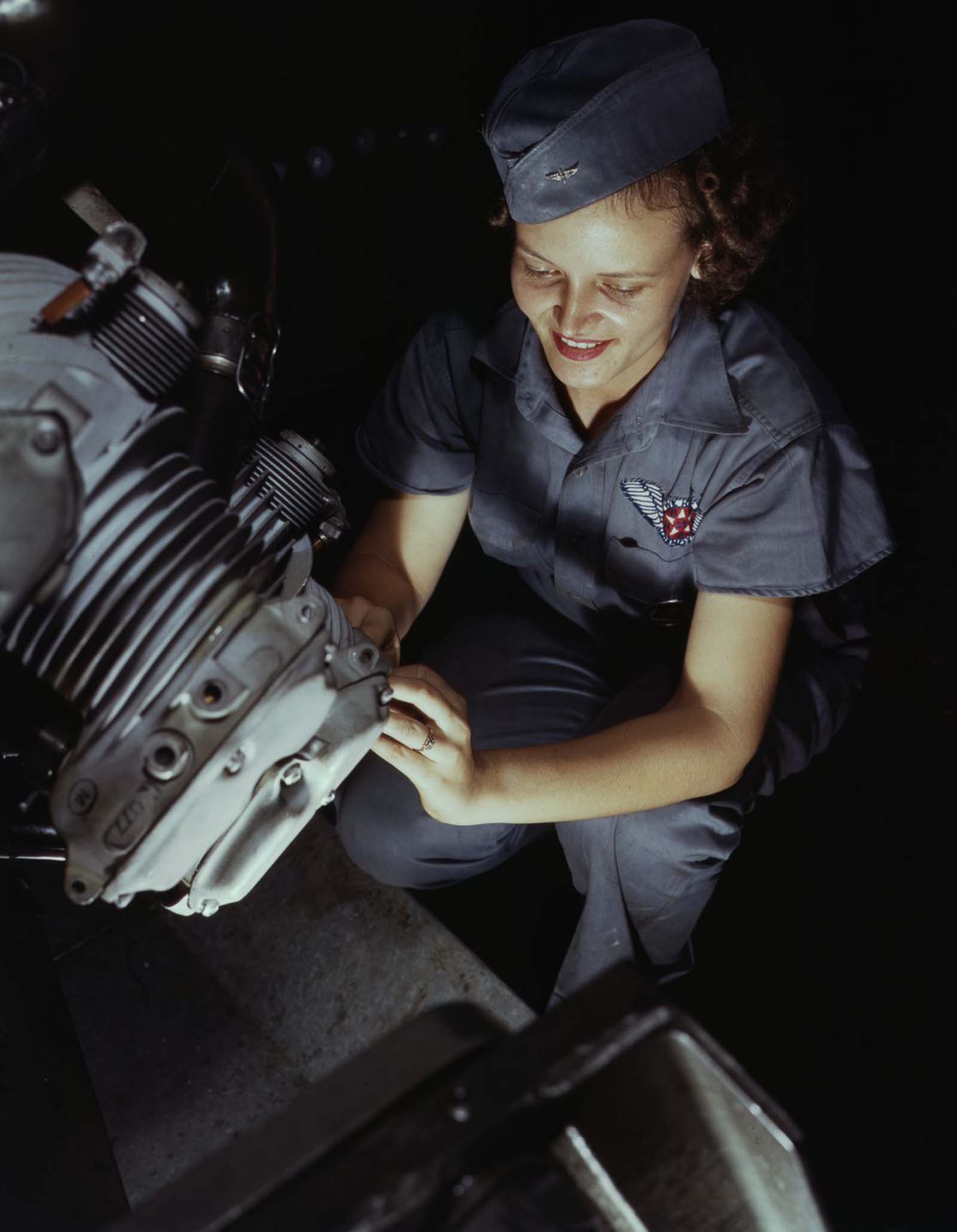 #22 Assembly and Repairs Dept. mechanic Mary Josephine Farley works on a Wright Whirlwind motor.