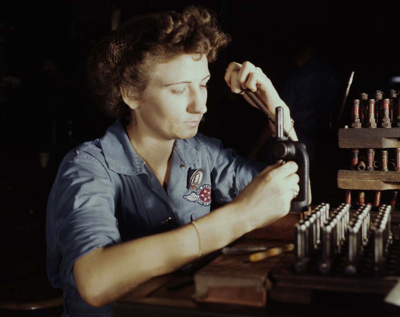 #8 Doris Duke works on reconditioning spark plugs in the Assembly and Repair Department.