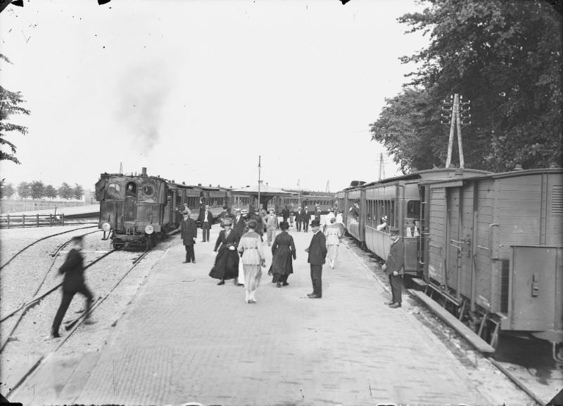 #19 Two steam trams at Bergen station, seen from the platform to the east. The locomotive is reversing towards the sea, 1914