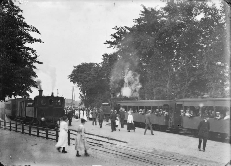 #20 Two steam trams at Bergen station, seen from the station square to the south-east. The locomotive is reversing towards the sea, 1914