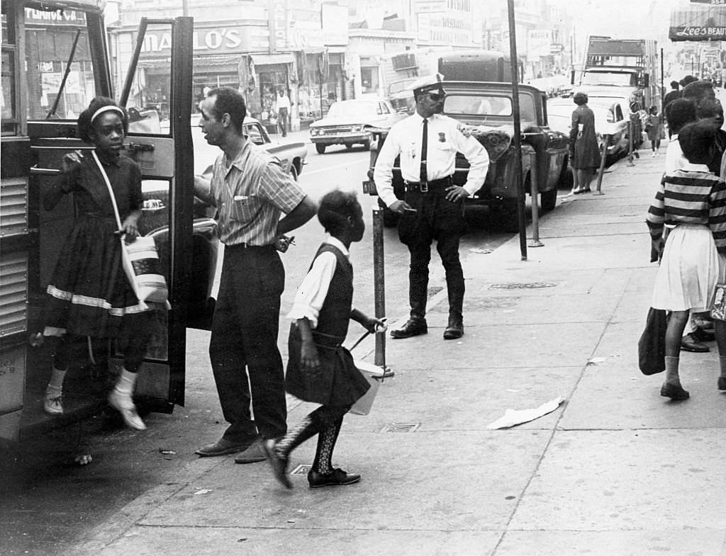 #103 Students get off the bus from a suburban school at the end of the school day in Boston, 1965.