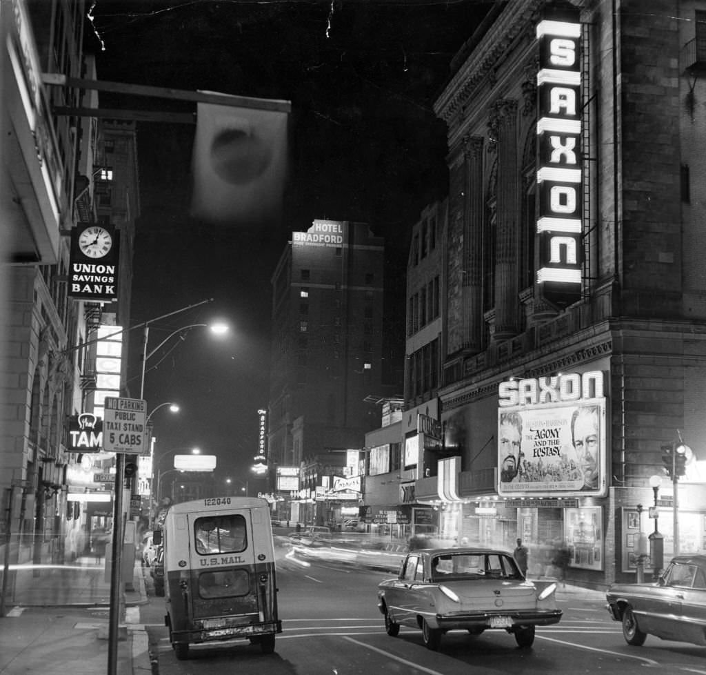 #108 Washington Street in Boston at night, Nov. 10, 1965. Saxon Theatre is on right, Union Savings Bank on left. (Photo by Phil Preston/The Boston Globe via Getty Images)