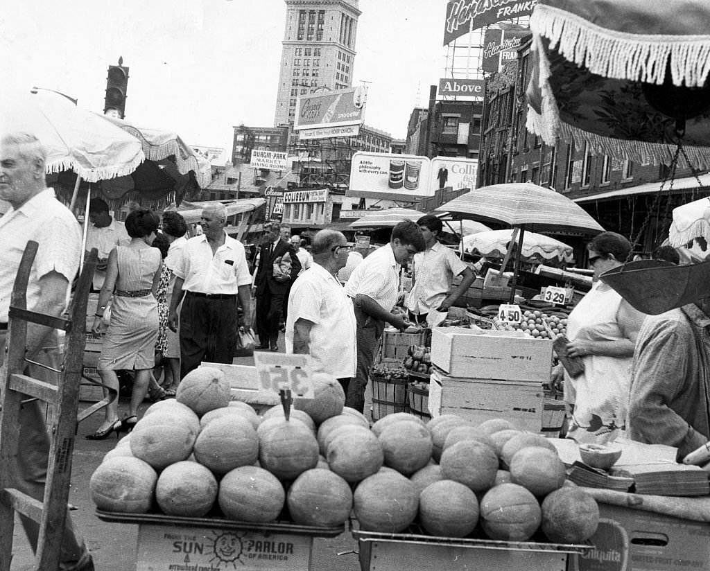 #120 The Custom House tower stands behind a busy Faneuil Hall marketplace in Boston on July 16, 1966.